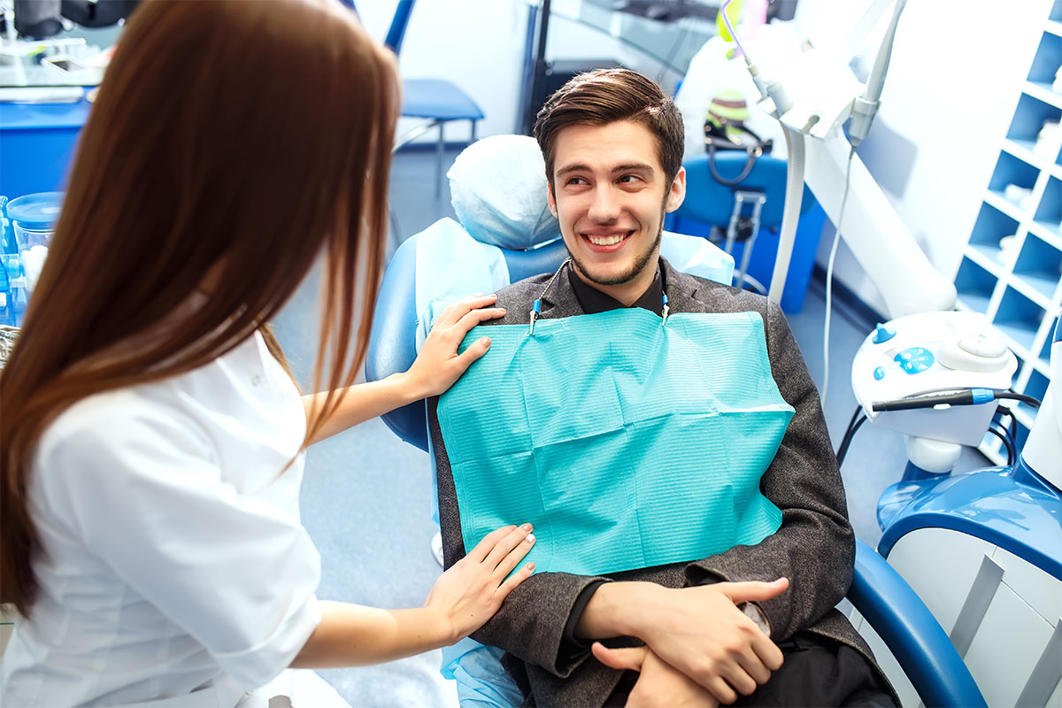 Dentist and patient in the dental